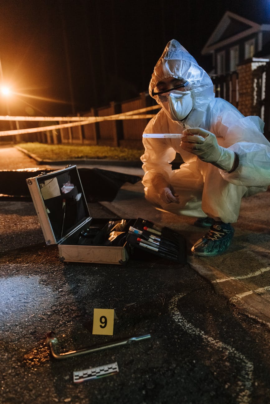 man in white hoodie holding black box