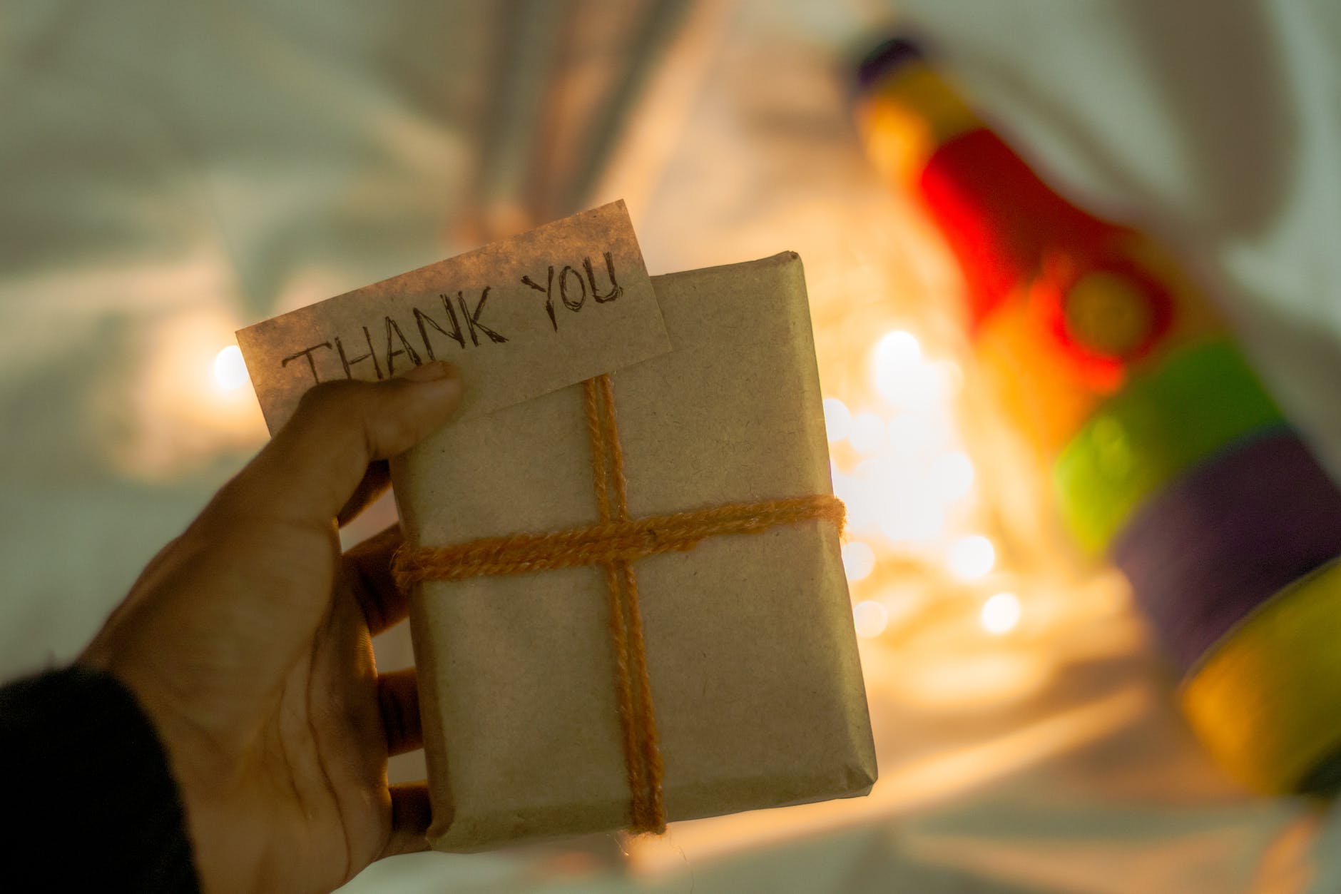 photograph of a person s hand holding a gift box